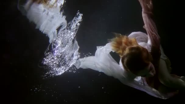 Underwater magic, sensual woman is floating in darkness, romantic and mysterious slow motion — Video