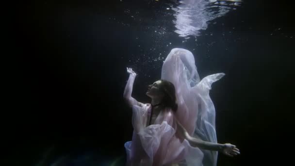 Beautiful tender woman is floating in deepness in sea or river, slow motion underwater shot — Vídeo de stock