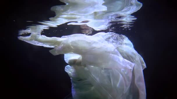 Sensual underwater shot, woman is floating in dark depth, slow motion swimming — Vídeo de stock