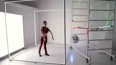 dancing in studio, sexy woman is performing dance and rehearsing, modern disco style