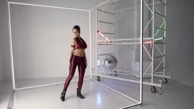 beautiful lady is dancing like robot, rehearsing in studio, creating new modern dance style