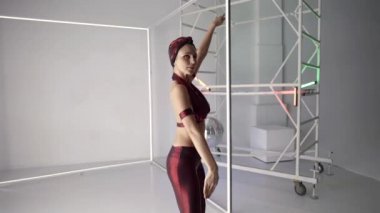 modern disco dancer woman is dancing alone in dance studio, alluring movements