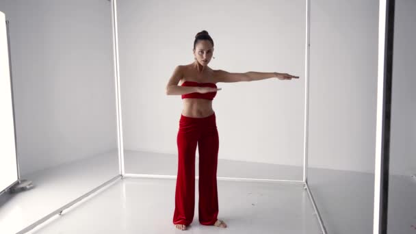 Stunning lady is dancing alone in studio, rehearsing modern dance style — стоковое видео