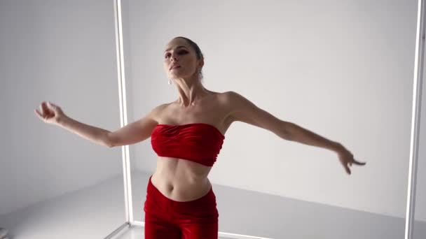 Modern belly dance improvisation, woman is dancing in studio, rehearsing new performance — стоковое видео