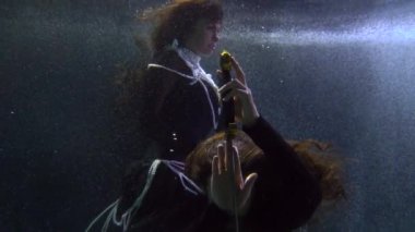 magic and mystery underwater, medieval elegant lady and brave knight with magical sword