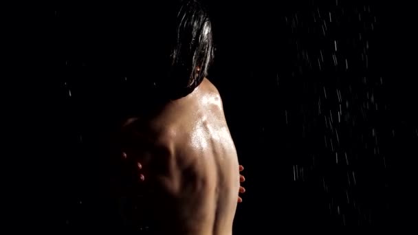 Erotic seductive shot of woman in water flows in darkness, rear view silhouette of female body — Video Stock