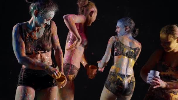 Funny hen party, young ladies are flinging paints on bodies and faces, smiling and laughing — Wideo stockowe