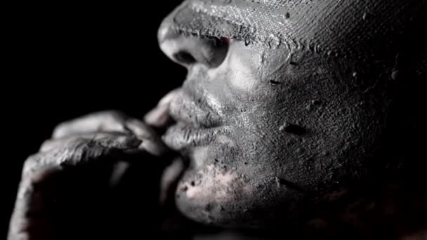 Tempting closeup shot of female face and lips covered by grey clay, strange and mysterious — Stock Video