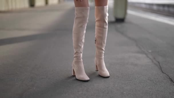 Sexy piernas delgadas hembra en botas ligeras y medias de rejilla en la calle, vista de cerca — Vídeo de stock
