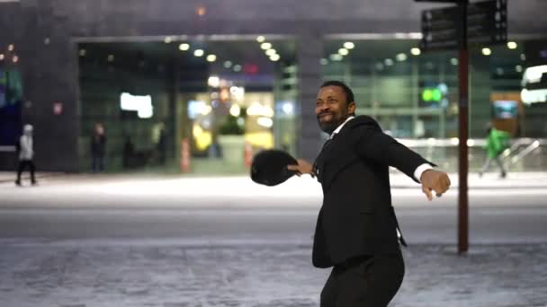 Felice uomo africano è gioire e giocare con tappo in città strada in inverno sera — Video Stock