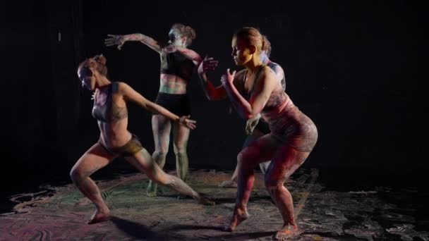 Quatre femmes sexy dansent danse moderne en studio sombre, la peau couverte de peintures — Video