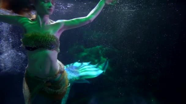 Изящная русалка с сказочным рыбным хвостом плавает в глубине моря, волшебный подводный кадр — стоковое видео