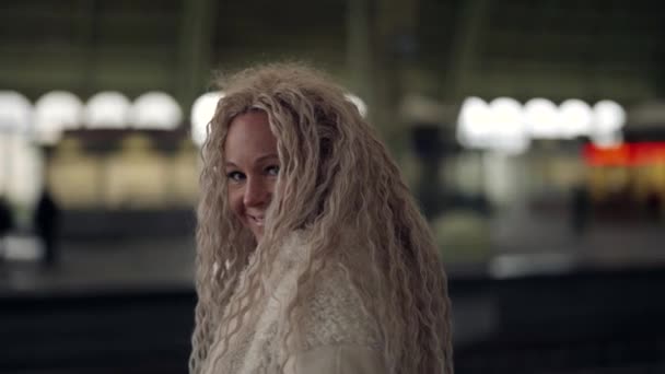 Attraktive Frau mit langen blonden Haaren läuft und demonstriert ihre schöne Frisur — Stockvideo
