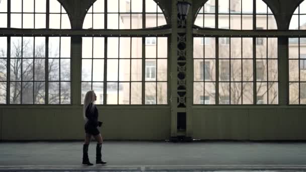 Sexy rubia mujer es caminar dentro de terminal de la vieja estación de tren — Vídeo de stock