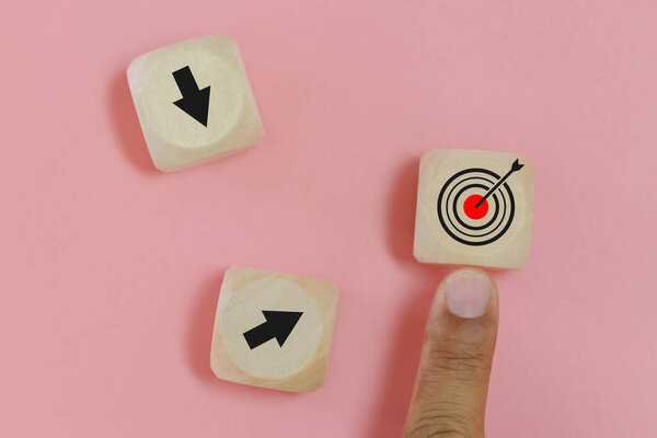 Hand of man finger pointing selection wooden cube blocks with Goal icon. Goal and target concept.