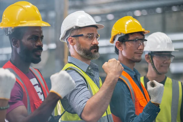 group of engineer professional successful team corporate workers standing in factory. teamwork technician inspector manufacturing industry workplace.