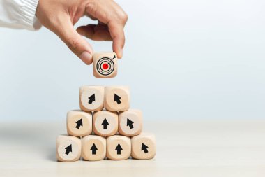 Hedefe adım atma kavramı. Hedef ikonlu tahta küp bloğu. Hedef iş büyümesi başarılı oldu. Vizyon takım çalışması şirketi ilerleme sağlıyor.