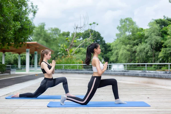 Relaxation yoga exercise concept. healthy leisure. Woman in sportswear yoga workout.  Female sitting yoga prayer position yoga on outdoor floor.