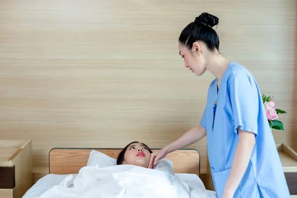 doctor visit and touch patient to examining symptom illness. young woman patient lying on hospital bed.