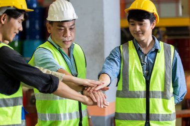 Success teamwork concept. engineer factory group joining hands, engineer team and partnership successful service support workshop.