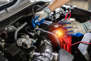 Ulaşım onarım servisi konsepti, Tamirci Oto Tamircisi Araç aküsünü kontrol ettikten sonra motor içinde kullanıldı. Erkek işçi servis motoru tamirhanesi.