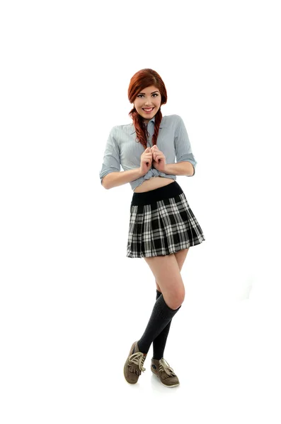 Happy schoolgirl pulling on her pig tails — Stock Photo, Image