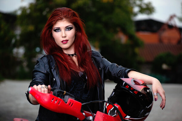 Portrait of an attractive redhead biker chick