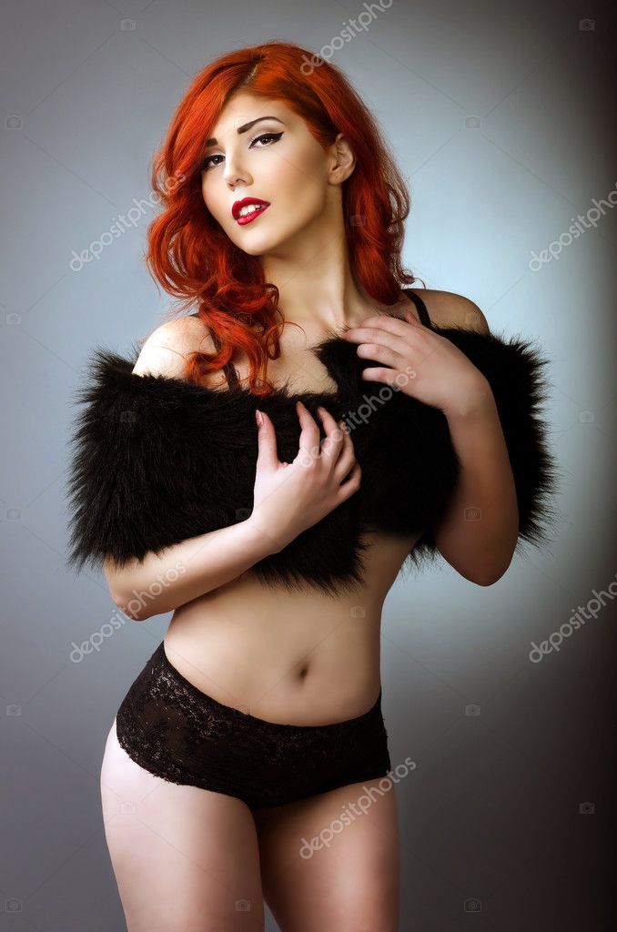 Glamorous Curvy Red Head Woman With A Sexy Body And Small Breasts Posing In  Black Lingerie On A Blue Studio Background With Vignetting Stock Photo,  Picture and Royalty Free Image. Image 156121884.