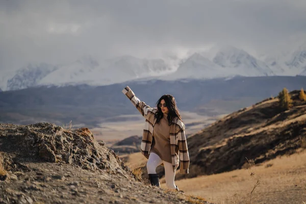 Belle fille élégante grimpe la montagne. Sur fond de pics enneigés blancs. ensoleillé. — Photo