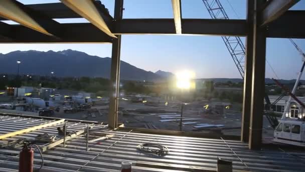 Drifting shot of construction site at sunrise. — Stock Video