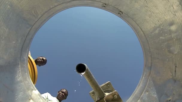 PORT AU PRINCE, HAITI - DECEMBER 17, 2013: Unidentified people watch as water fills bucket at well in the outskirts of Port au Prince, Haiti. (For editorial use only.) — Stock Video