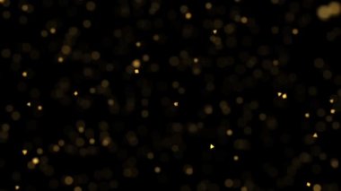 Bokeh etkisi, altın parçacıklar ve siyah arka planda bulanık sihirli toz, parlak parıltılı tatil partisi animasyon duvar kâğıdı, karanlık lüks ışıltılı hd animasyon.