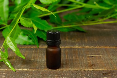 şişedeki yağ ve ahşap arka plandaki yaprak..