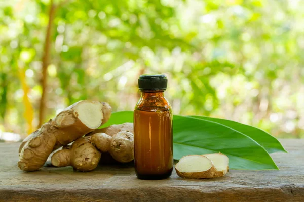 Ginger Essential Oil Bottle Fresh Ginger Rustic Wooden Blur Background — Stock Photo, Image