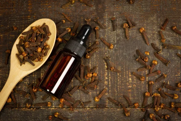 Essential Oil Cloves Bottle Dry Cloves Wooden Spoon Rustic Wooden — Stock Photo, Image