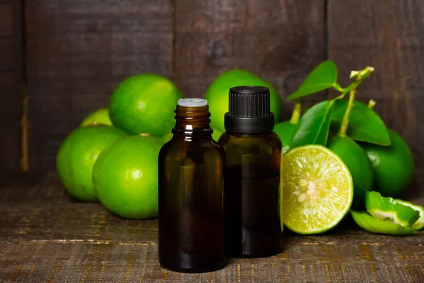 Lime Essential Oil Glass Bottle Fresh Lime Fruits Green Leaf — Stock Photo, Image