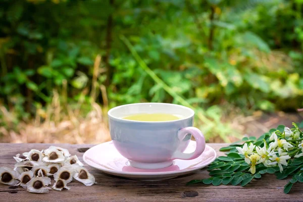 Moringa Tea Cup Fresh Green Leaf Flower Seeds Wooden Blur — стоковое фото