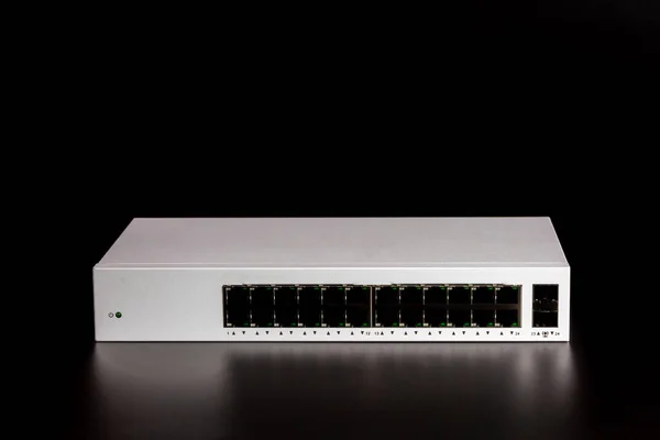 24-port gigabit switch white color isolated on black background. Components to create local area network for share data and device.