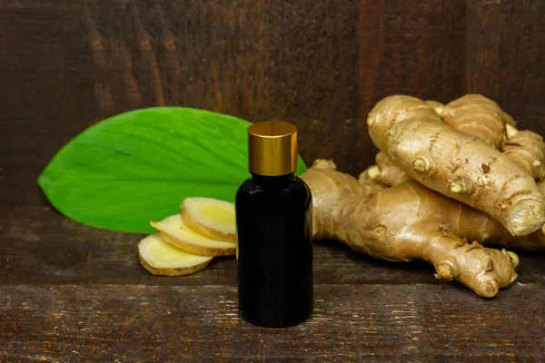 Ginger Essential Oil Bottle Fresh Ginger Green Leaf Rustic Wooden — стоковое фото