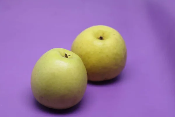 Two Yellow Apple Fruit Purple Background — Zdjęcie stockowe