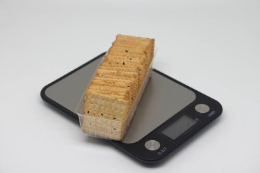 Cookies lie on a kitchen electronic scale, calorie counting. Diet