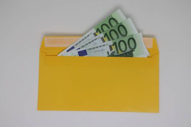 Glasses. banknotes in a yellow envelope. open envelope with banknotes on a light background. envelope with banknotes. close-up of an envelope with cash. international currency banknote. Euro dollars rubles