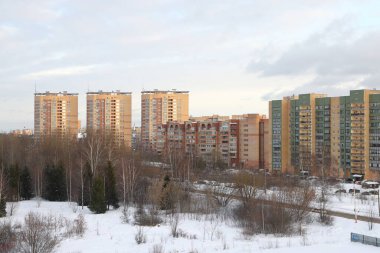New snow covered high rise residential buildings in a Russian city. Moscow region, January 2022