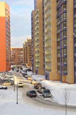New snow covered high rise residential buildings in a Russian city. Moscow region, January 2022