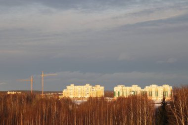 New snow covered high rise residential buildings in a Russian city. Moscow region, January 2022