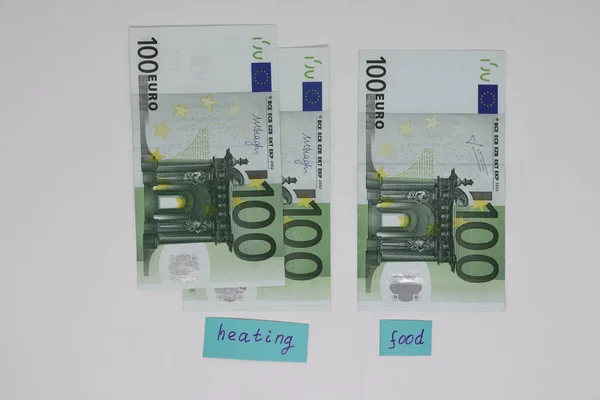 Banknotes with heating and food signs. The concept is to increase the cost of heating, payment for natural gas. Energy crisis. High cost, gas price