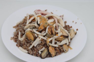 Bir kâsede marine edilmiş deniz ürünleri kokteyli, karabuğday lapası için meze.