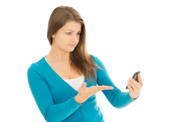 Beautiful woman looks at phone angry — Stock Photo, Image