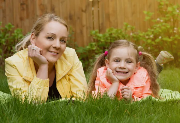 Happy family laying at grass — Stock Photo, Image