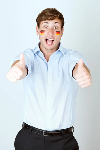 Footbal fan with germany flag painted at the face shows thumb up — Stock Photo, Image